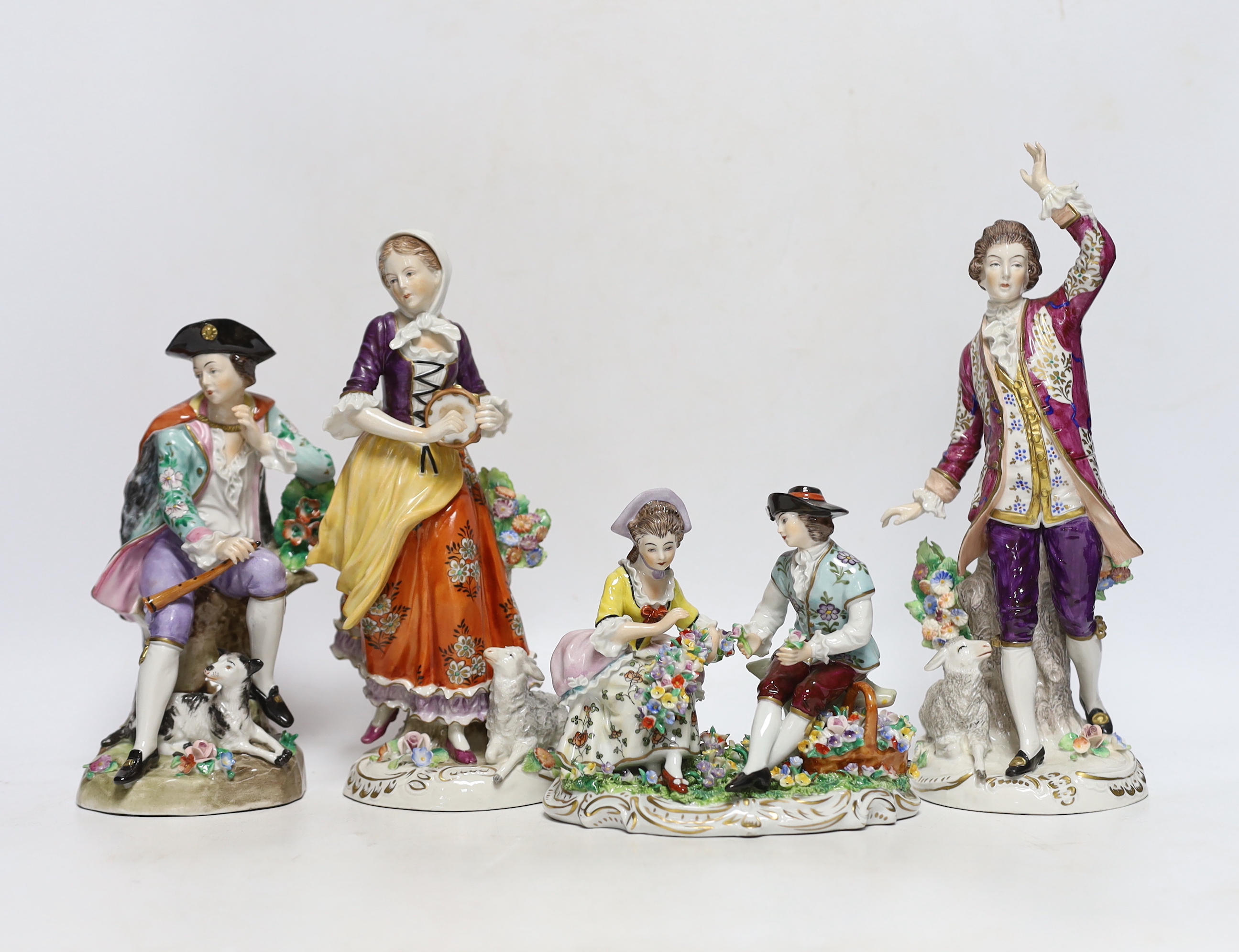 Four Sitzendorf porcelain figures in groups, early 20th century, 26cm